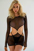 A woman wearing a black sheer mesh dress with long sleeves and cut-out details.