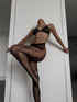A pair of fishnet stockings with a lace pattern, featuring a bold design with fishnet sides and a hook and eye closure at the thigh.