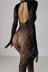 A person wearing a transparent black bodysuit with a geometric pattern, featuring a deep V-back.